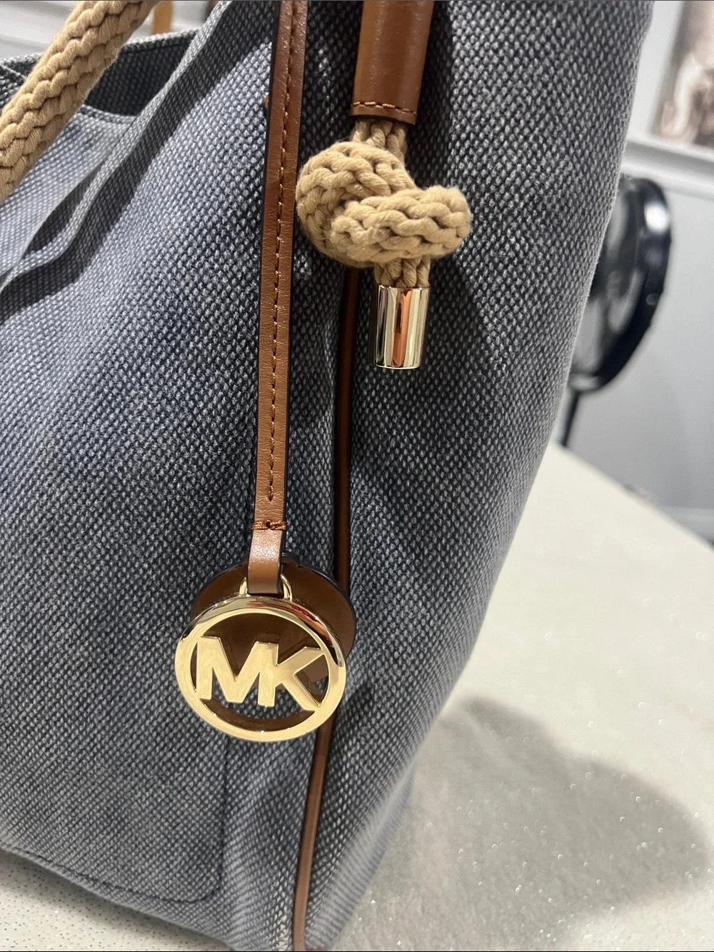 Michael Kors Isla Large Tote Bag, washed denim with signature rope handles.